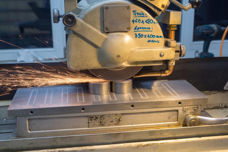 Sparks flying during surface grinding on the Tripet