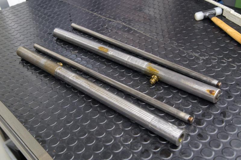 Hydraulic cylinder pistons on a workbench