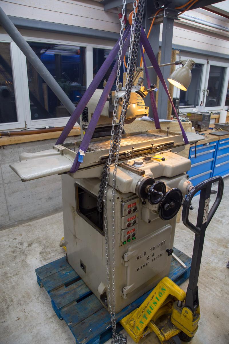 Tripet suspended from an overhead crane with a pallet jack underneath
