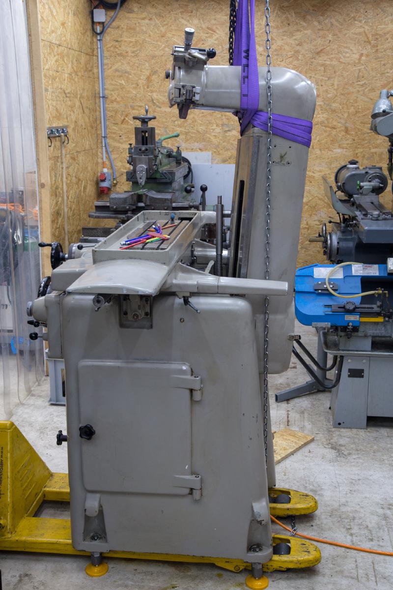 Tripet head and column hanging from an overhead crane